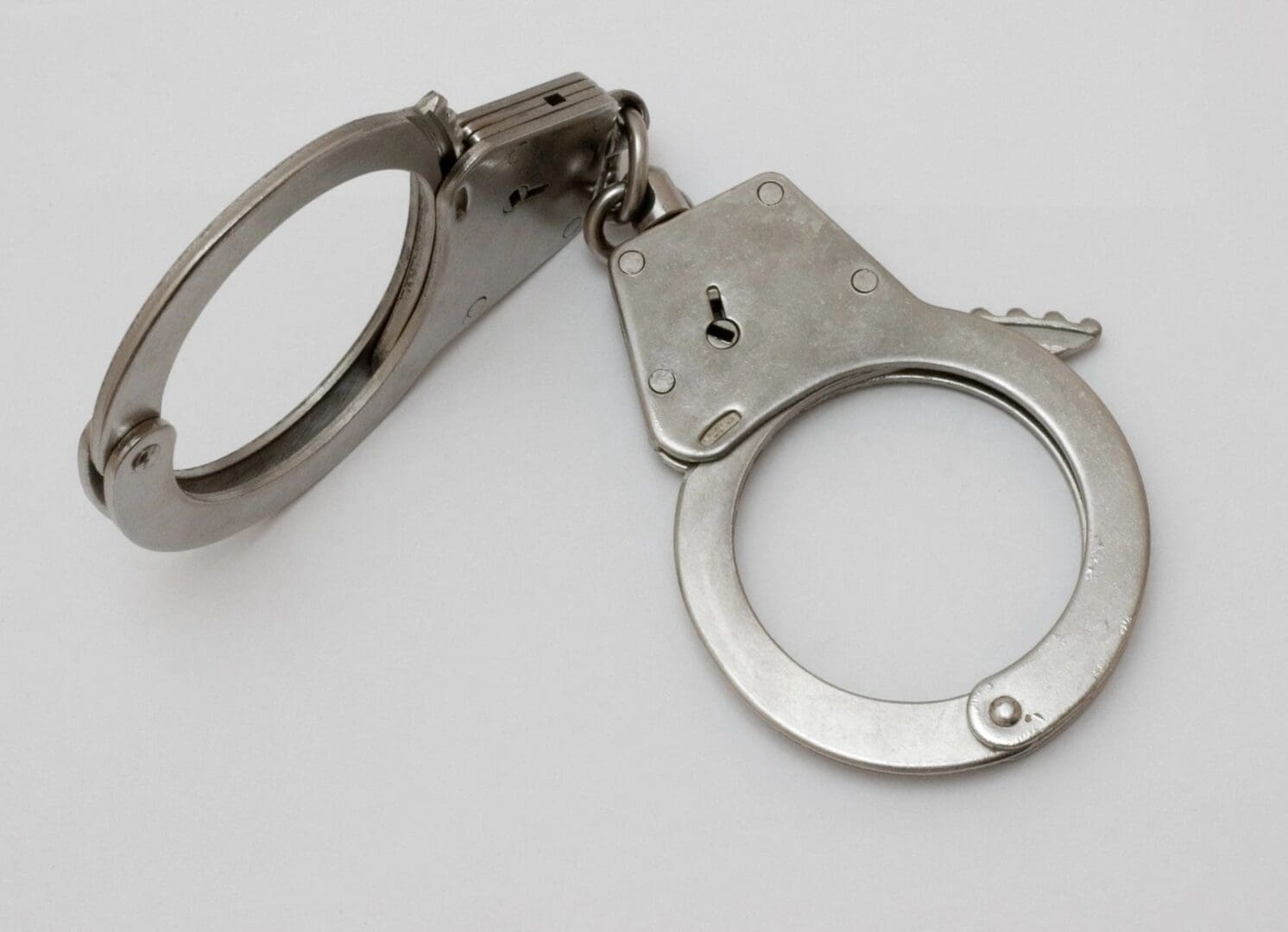 A pair of handcuffs on top of a white table.