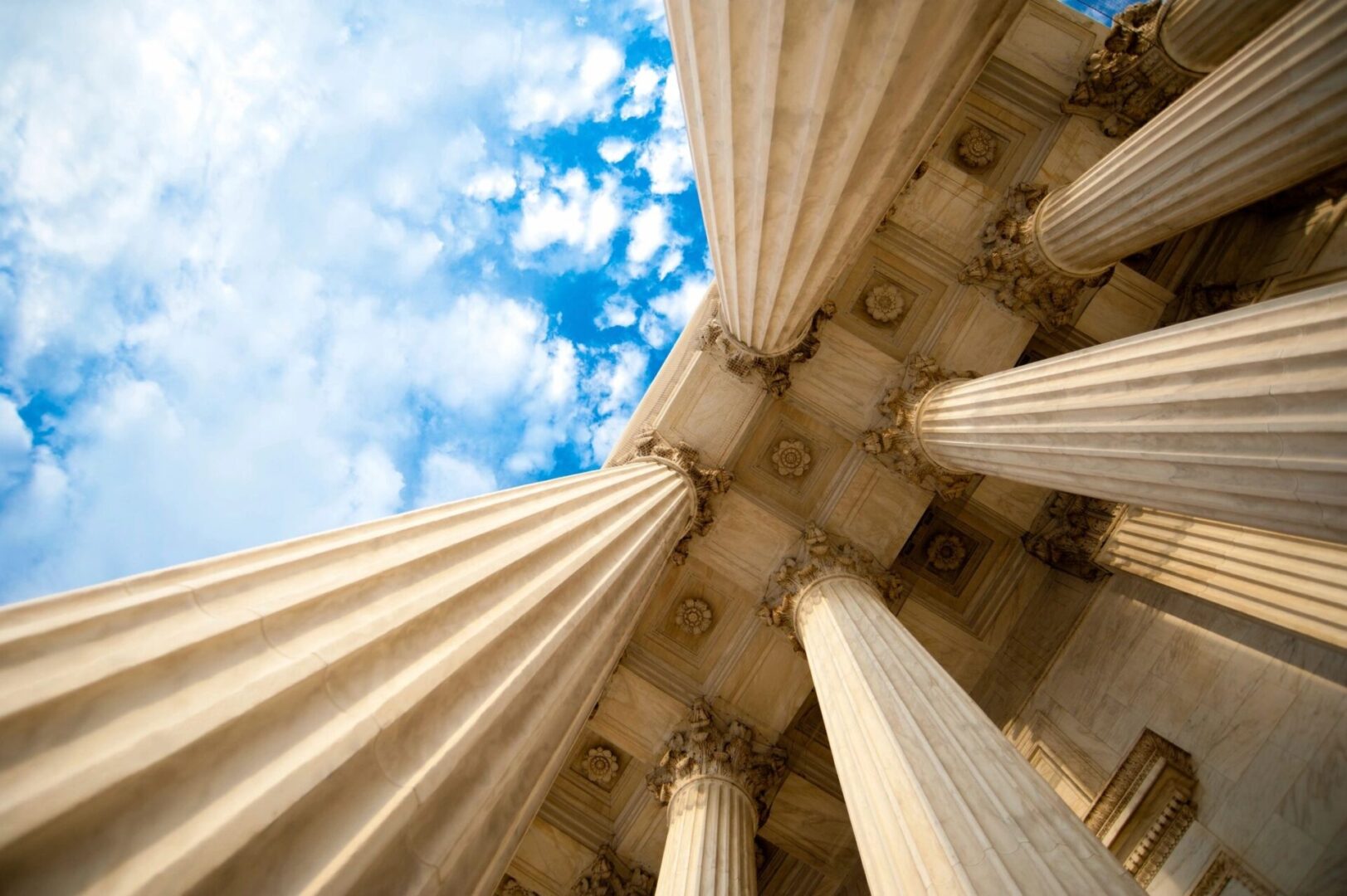 A view of the top of four pillars in an old building.