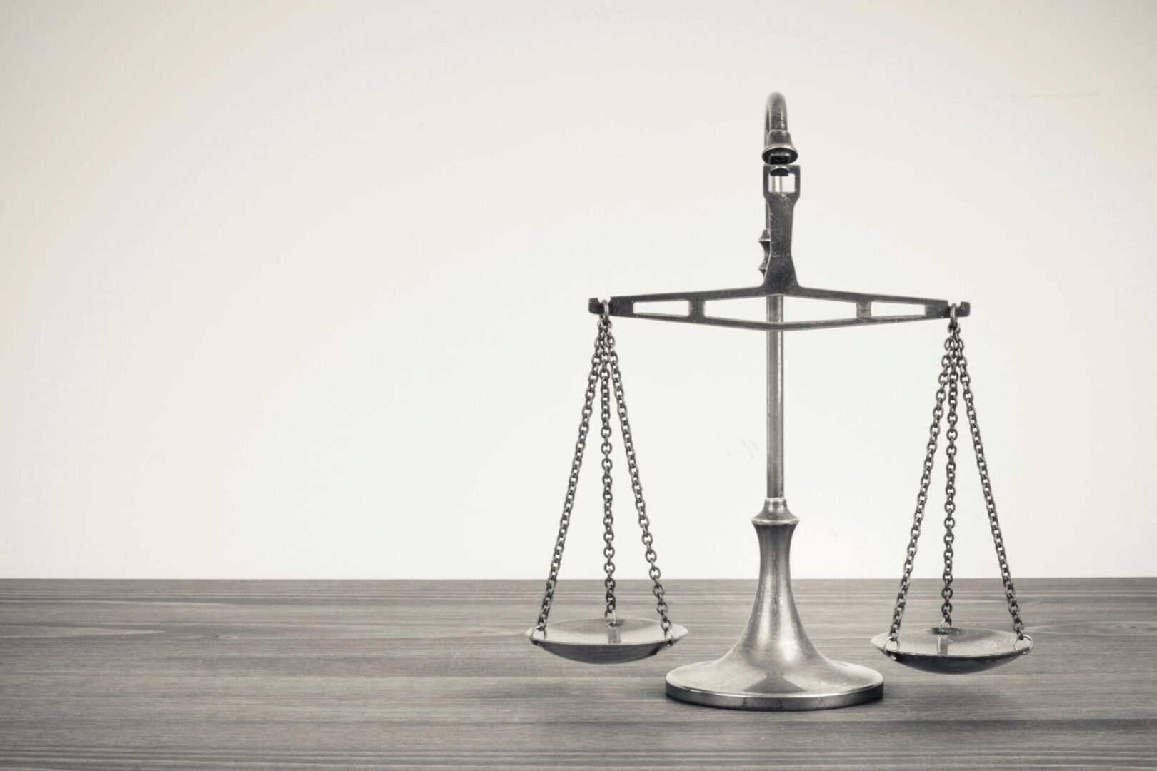 A silver scale sitting on top of a wooden table.