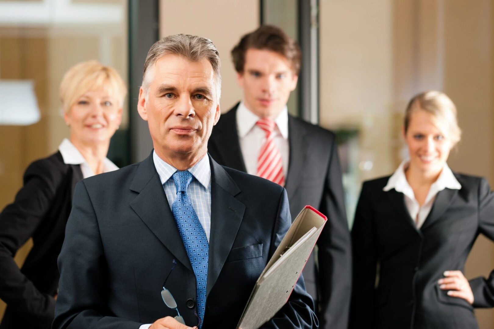 A group of people in suits and ties standing together.