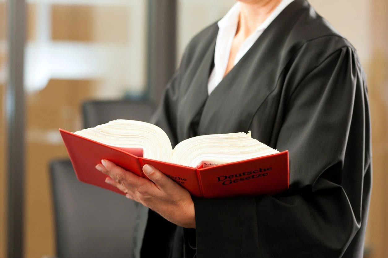 A judge holding an open book in her hands.