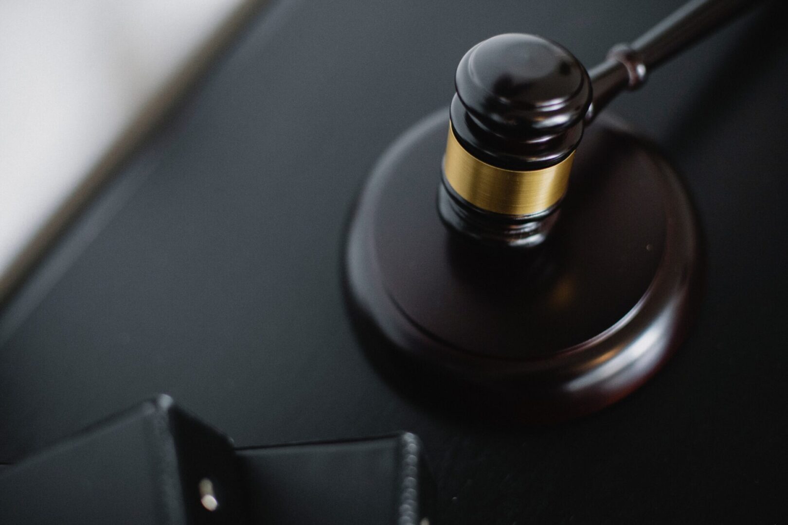 A judge 's gavel sitting on top of a table.