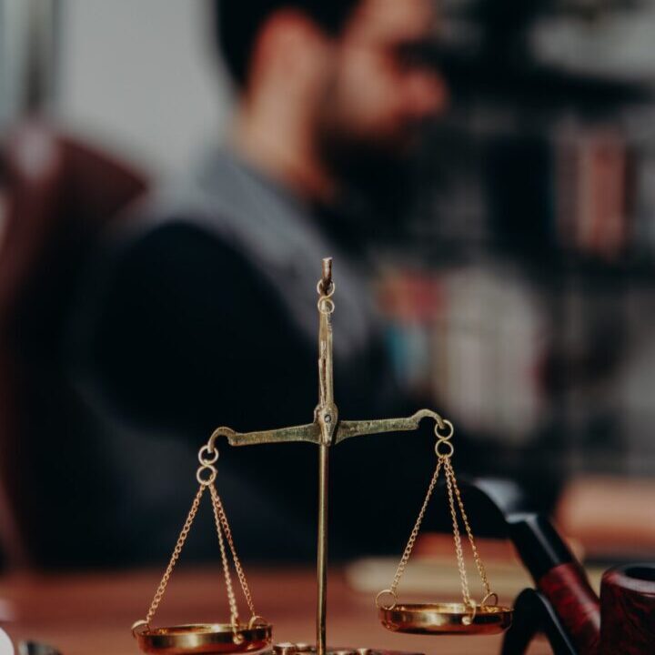 A person is sitting at a table with a scale.